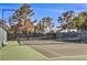 Professionally maintained tennis court features lush landscaping, and well-kept court surface at 7772 Buckwood Ct, Las Vegas, NV 89149
