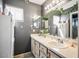 Spacious bathroom with double sinks, a large mirror, and neutral countertops at 7820 Esteem St, Las Vegas, NV 89131