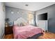 Cozy bedroom featuring a comfortable bed, white dresser, and hardwood floors at 7820 Esteem St, Las Vegas, NV 89131