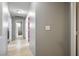 Interior hallway featuring light gray walls, white trim and light vinyl floors at 7820 Esteem St, Las Vegas, NV 89131