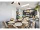 Modern kitchen features dark cabinetry, granite countertops, and an adjacent dining space at 7820 Esteem St, Las Vegas, NV 89131