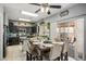 Stylish kitchen and dining area with dark cabinetry, stainless appliances, and ample lighting at 7820 Esteem St, Las Vegas, NV 89131