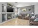 Comfortable living room showcasing a media niche, tile floors, and stylish gray walls at 7820 Esteem St, Las Vegas, NV 89131