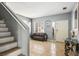 Inviting Living Room with tile floors, a stylish sofa, and staircase at 7820 Esteem St, Las Vegas, NV 89131