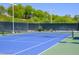 Well-maintained tennis court with a blue playing surface and a surrounding fence at 7820 Esteem St, Las Vegas, NV 89131