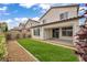 Spacious backyard featuring a covered patio and well-manicured lawn at 9947 Fletcher Peak Ave, Las Vegas, NV 89178