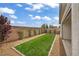 Landscaped backyard featuring a well-maintained lawn and shrubbery at 9947 Fletcher Peak Ave, Las Vegas, NV 89178