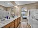 This bathroom features a dual sink vanity and a view into the bedroom, with a seamless glass shower at 9947 Fletcher Peak Ave, Las Vegas, NV 89178
