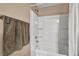Clean white shower and tub combination with brushed nickel fixtures and towel rack at 9947 Fletcher Peak Ave, Las Vegas, NV 89178