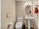 Cozy half bathroom featuring a pedestal sink and wood-look flooring at 9947 Fletcher Peak Ave, Las Vegas, NV 89178