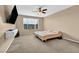 Neutral bedroom features a ceiling fan, natural light, and neutral carpeting at 9947 Fletcher Peak Ave, Las Vegas, NV 89178