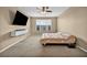 Neutral bedroom featuring a ceiling fan, natural light, and neutral carpeting at 9947 Fletcher Peak Ave, Las Vegas, NV 89178