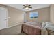 Well-lit bedroom with neutral tones, soft carpet and a view of the landscape at 9947 Fletcher Peak Ave, Las Vegas, NV 89178
