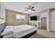 Inviting bedroom with a ceiling fan, large window, and stylish decor at 9947 Fletcher Peak Ave, Las Vegas, NV 89178