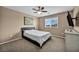 Cozy bedroom featuring a comfortable bed, ceiling fan, and a bright window view at 9947 Fletcher Peak Ave, Las Vegas, NV 89178
