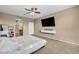 Spacious main bedroom featuring a ceiling fan, television, and en-suite bathroom at 9947 Fletcher Peak Ave, Las Vegas, NV 89178