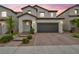 Two-story home features a tile roof, desert landscaping, and a two-car garage at 9947 Fletcher Peak Ave, Las Vegas, NV 89178