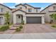 Two-story home features a tile roof, desert landscaping, and a two-car garage at 9947 Fletcher Peak Ave, Las Vegas, NV 89178