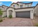 Two-story home features a tile roof, desert landscaping, and a two-car garage at 9947 Fletcher Peak Ave, Las Vegas, NV 89178