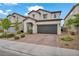 Two-story home features a tile roof, desert landscaping, and a two-car garage at 9947 Fletcher Peak Ave, Las Vegas, NV 89178