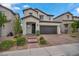 Two-story home features a tile roof, desert landscaping, and a two-car garage at 9947 Fletcher Peak Ave, Las Vegas, NV 89178