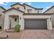 Two-story home features a tile roof, desert landscaping, and a two-car garage at 9947 Fletcher Peak Ave, Las Vegas, NV 89178