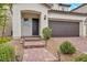 Exterior of home with desert landscaping and a covered entrance at 9947 Fletcher Peak Ave, Las Vegas, NV 89178