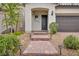 Exterior of home with desert landscaping and a covered entrance at 9947 Fletcher Peak Ave, Las Vegas, NV 89178