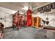 Spacious home gym, showcasing a weight rack, punching bag, and sauna at 9947 Fletcher Peak Ave, Las Vegas, NV 89178