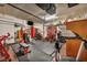 Home gym featuring a treadmill, weight rack, punching bag, and ample storage at 9947 Fletcher Peak Ave, Las Vegas, NV 89178