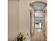 Hallway with plant decor leading to a living room with modern furnishings at 9947 Fletcher Peak Ave, Las Vegas, NV 89178