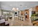 Bright, open-concept living area with hardwood floors and a central kitchen island at 9947 Fletcher Peak Ave, Las Vegas, NV 89178