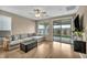 Bright living room boasts a sliding glass door with backyard access and comfortable seating at 9947 Fletcher Peak Ave, Las Vegas, NV 89178