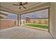Covered patio with sun shades overlooking a neatly kept backyard at 9947 Fletcher Peak Ave, Las Vegas, NV 89178