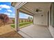 Covered patio with ceiling fan overlooking landscaped backyard and views of blue skies at 9947 Fletcher Peak Ave, Las Vegas, NV 89178