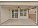 Covered patio featuring a ceiling fan and slider with well-maintained yard at 9947 Fletcher Peak Ave, Las Vegas, NV 89178
