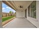 Covered patio featuring a ceiling fan, and views of a well-maintained yard at 9947 Fletcher Peak Ave, Las Vegas, NV 89178