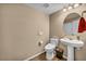Stylish powder room with modern sink, toilet, mirror, and laminate flooring at 9947 Fletcher Peak Ave, Las Vegas, NV 89178