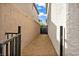 Narrow side yard with gravel landscaping and a security gate at 9947 Fletcher Peak Ave, Las Vegas, NV 89178