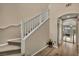 Staircase with carpet and wood floors leading to the upper level of the home at 9947 Fletcher Peak Ave, Las Vegas, NV 89178