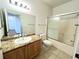 Bathroom featuring tiled floor, granite countertop, single vanity, and shower/tub at 1521 Ruby Cliffs Ln # 104, Las Vegas, NV 89144