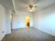 Bedroom with carpet floor, ceiling fan, and attached bathroom at 1521 Ruby Cliffs Ln # 104, Las Vegas, NV 89144