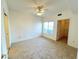 Spacious bedroom with a ceiling fan, carpet flooring, and a closet at 1521 Ruby Cliffs Ln # 104, Las Vegas, NV 89144