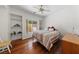 Cozy bedroom with hardwood floors, a ceiling fan, and a view to the exterior through a window at 1900 Bellview St, Las Vegas, NV 89134