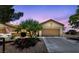 Charming single-story home with a well-maintained lawn, two-car garage, and a inviting front entrance at 1900 Bellview St, Las Vegas, NV 89134