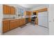 Functional kitchen with stainless steel appliances and honey colored wood cabinetry and neutral countertops at 1900 Bellview St, Las Vegas, NV 89134