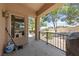 Cozy covered patio with metal railing, offering a view of the desert landscape and mature trees at 1900 Bellview St, Las Vegas, NV 89134