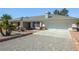 Charming single-story home featuring a two-car garage, desert landscaping, and a neutral-toned exterior at 2040 Tucuman Ave, Pahrump, NV 89048
