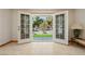 Sunlit living room with tile flooring, featuring an open view to a manicured backyard at 2040 Tucuman Ave, Pahrump, NV 89048