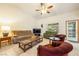 Inviting living room with neutral tones, tile flooring, ceiling fan, and comfortable seating arrangements for relaxation at 2040 Tucuman Ave, Pahrump, NV 89048